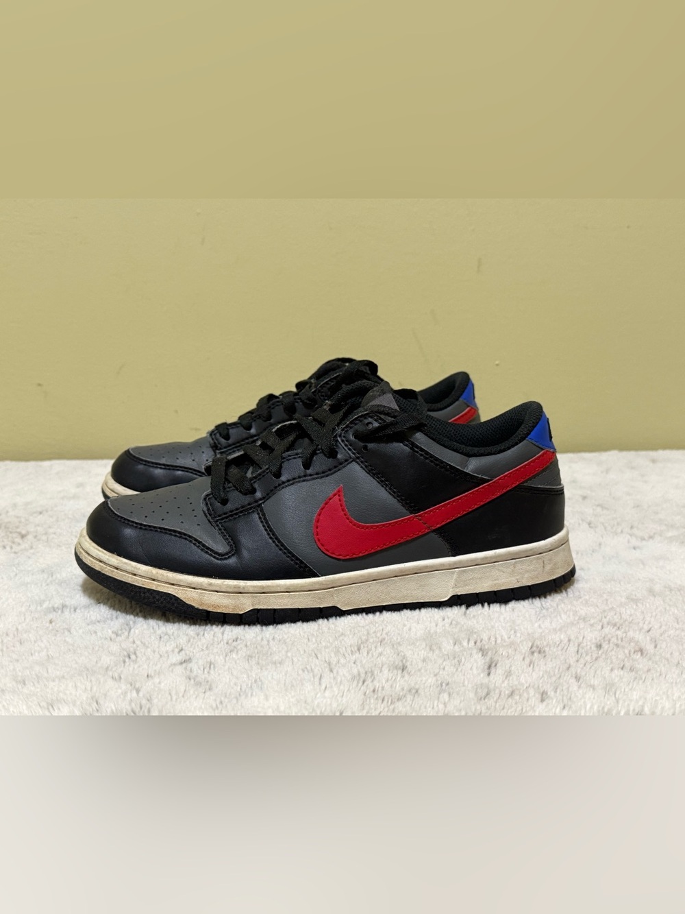 Nike Black Leather Low-Top Sneakers with Red Swoosh and Blue Heel Accent